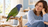 Blue-headed Pionus parrot calmly sharing time with a nearby caregiver